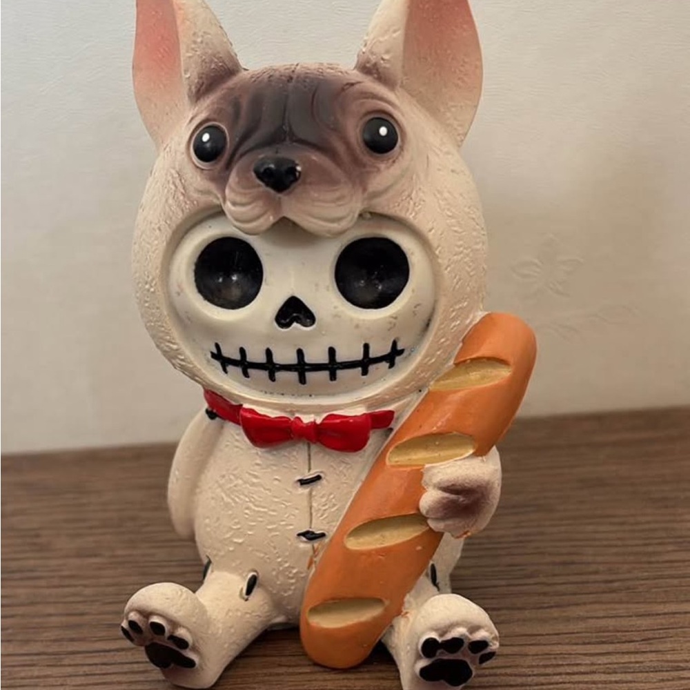 Skeleton in Gentleman French Bulldog costume w/ red bow tie holding French bread